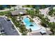 Aerial view of community pool with seating, palm trees, and lake views at 11223 Spring Gate Trl, Bradenton, FL 34211