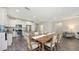 Open dining and kitchen area with stainless steel appliances, granite island seating, and wood table at 11223 Spring Gate Trl, Bradenton, FL 34211