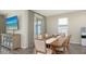 Dining area featuring a large wood table, elegant curtains, and view of the lanai at 11223 Spring Gate Trl, Bradenton, FL 34211