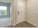 Inviting foyer with tile floors, a front door, and doorway to the bedroom at 11223 Spring Gate Trl, Bradenton, FL 34211