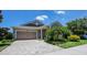 Charming front of single Gathering home with a stone driveway, lawn and desert landscaping at 11223 Spring Gate Trl, Bradenton, FL 34211