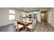 Spacious dining room and kitchen area with stainless steel appliances and white shaker cabinetry at 11223 Spring Gate Trl, Bradenton, FL 34211