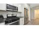 Well lit kitchen with stainless steel appliances, granite counters and subway tile backsplash at 11223 Spring Gate Trl, Bradenton, FL 34211