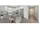 Kitchen with a granite island, white cabinets, stainless steel appliances, tile flooring, and an open layout at 11223 Spring Gate Trl, Bradenton, FL 34211