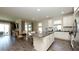 Bright kitchen featuring white cabinetry, stainless steel appliances, granite counters, and a dining area at 11223 Spring Gate Trl, Bradenton, FL 34211