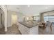 Open kitchen showcasing a granite island with seating flowing into the living and dining areas at 11223 Spring Gate Trl, Bradenton, FL 34211