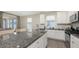 Kitchen showcases a granite island, white cabinets, stainless steel appliances, tile flooring, and an adjacent dining area at 11223 Spring Gate Trl, Bradenton, FL 34211