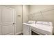 Functional laundry room featuring a modern washer and dryer, with a sleek rack for added convenience at 11223 Spring Gate Trl, Bradenton, FL 34211