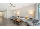 Comfortable living room with neutral decor, ceiling fan, tile flooring, and stylish furniture at 11223 Spring Gate Trl, Bradenton, FL 34211