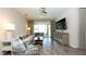 Comfortable living room featuring wood-look tile floors and sliding glass doors to outdoor seating area at 11223 Spring Gate Trl, Bradenton, FL 34211