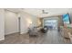 Bright living room with tile flooring, ceiling fan, and sliding glass doors leading to a patio at 11223 Spring Gate Trl, Bradenton, FL 34211