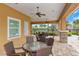 Outdoor seating area with tables, chairs, ceiling fans and views of trees and sky at 11223 Spring Gate Trl, Bradenton, FL 34211