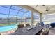 Covered patio with beautiful outdoor dining area overlooking the pool and well-manicured backyard at 11223 Spring Gate Trl, Bradenton, FL 34211