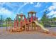 Community playground area with slides, ladders, and swings on mulch ground at 11223 Spring Gate Trl, Bradenton, FL 34211