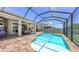 Backyard featuring a screened-in pool, paved patio with seating, and a clear view of the sky above at 11223 Spring Gate Trl, Bradenton, FL 34211