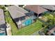 Aerial view of a screened-in pool in a well-maintained backyard oasis at 11223 Spring Gate Trl, Bradenton, FL 34211