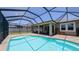 Inviting screened-in pool with paver patio and covered porch, perfect for enjoying the outdoors at 11223 Spring Gate Trl, Bradenton, FL 34211