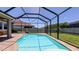 Screened-in pool area with a lovely pool and brick paver deck, perfect for relaxing and entertaining at 11223 Spring Gate Trl, Bradenton, FL 34211