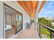 Balcony with wood floors, outdoor furniture, wood ceiling, and view of palm trees at 119 Avenida Messina, Sarasota, FL 34242