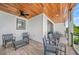 Covered balcony with outdoor seating, offering a comfortable space to relax and enjoy the views at 119 Avenida Messina, Sarasota, FL 34242