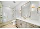 Chic bathroom with a glass shower, gold fixtures, and modern vanity at 119 Avenida Messina, Sarasota, FL 34242