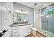 Modern bathroom featuring a glass-enclosed shower with stone flooring and a white vanity with a gray countertop at 119 Avenida Messina, Sarasota, FL 34242