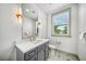 Modern bathroom with elegant vanity, marble countertop, and decorative tile flooring at 119 Avenida Messina, Sarasota, FL 34242