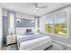 Beautiful bedroom with a large window, blue accent wall, and white ceiling fan at 119 Avenida Messina, Sarasota, FL 34242