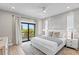 Serene bedroom featuring a balcony, large windows, a ceiling fan, and a decorative wall at 119 Avenida Messina, Sarasota, FL 34242