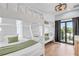 Bright bedroom featuring bunk beds with white wood and gray walls, and natural light from the door to the balcony at 119 Avenida Messina, Sarasota, FL 34242