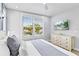 Bright bedroom with a large window, comfortable bed, and modern dresser at 119 Avenida Messina, Sarasota, FL 34242