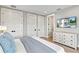 Neutral bedroom with a TV, closets, and a dresser at 119 Avenida Messina, Sarasota, FL 34242