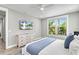 Comfortable bedroom featuring modern dresser, mounted TV, and bright window at 119 Avenida Messina, Sarasota, FL 34242