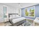 Well-lit bedroom with an accent wall, large windows, and contemporary decor at 119 Avenida Messina, Sarasota, FL 34242