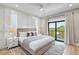 Comfortable bedroom featuring an accent wall, natural light, and modern decor at 119 Avenida Messina, Sarasota, FL 34242