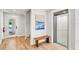 Entryway featuring a modern elevator and a bench beneath a blue abstract painting at 119 Avenida Messina, Sarasota, FL 34242