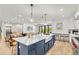 Open-concept kitchen with a large island and view to dining and living areas at 119 Avenida Messina, Sarasota, FL 34242