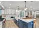 Kitchen with white cabinets, stainless steel appliances, and a large center island at 119 Avenida Messina, Sarasota, FL 34242