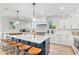 Bright, spacious kitchen with a large island, white cabinets, and modern appliances at 119 Avenida Messina, Sarasota, FL 34242
