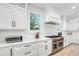 Bright kitchen features white cabinetry, stainless steel appliances, and quartz countertops at 119 Avenida Messina, Sarasota, FL 34242