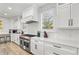 Bright kitchen with white countertops, stainless steel range, and modern cabinetry at 119 Avenida Messina, Sarasota, FL 34242