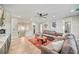Living room area with large sectional, round table, and stairway at 119 Avenida Messina, Sarasota, FL 34242