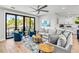Stylish living room with plush seating, modern décor, and a large sliding glass door to the balcony at 119 Avenida Messina, Sarasota, FL 34242