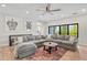 Spacious living room features a comfortable sectional sofa, turtle art prints, and beautiful outdoor views at 119 Avenida Messina, Sarasota, FL 34242