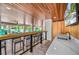 Outdoor bar features wood ceiling, bar with chairs, sink, and wall-mounted TV, perfect for entertaining at 119 Avenida Messina, Sarasota, FL 34242