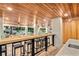 Spacious outdoor bar with wooden ceiling, countertop seating, and a view of the pool and backyard at 119 Avenida Messina, Sarasota, FL 34242