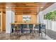 Outdoor bar featuring wood ceiling, bar with chairs, and wall-mounted TV, perfect for entertaining at 119 Avenida Messina, Sarasota, FL 34242