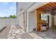 Outdoor shower and adjacent entertainment area with a wall mounted TV and wood paneling at 119 Avenida Messina, Sarasota, FL 34242