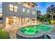 Backyard view featuring a pool and spa, and outdoor seating, perfect for evening gatherings at 119 Avenida Messina, Sarasota, FL 34242