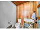 Modern half bath featuring custom wood wall, vessel sink, and contemporary fixtures at 119 Avenida Messina, Sarasota, FL 34242